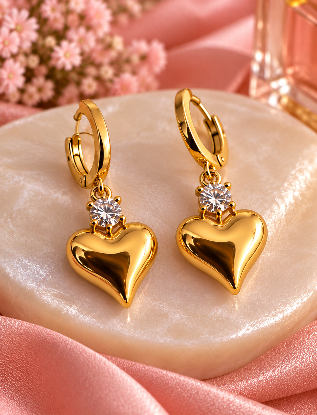 Close-up of gold heart drop earrings; pendant sold together in set